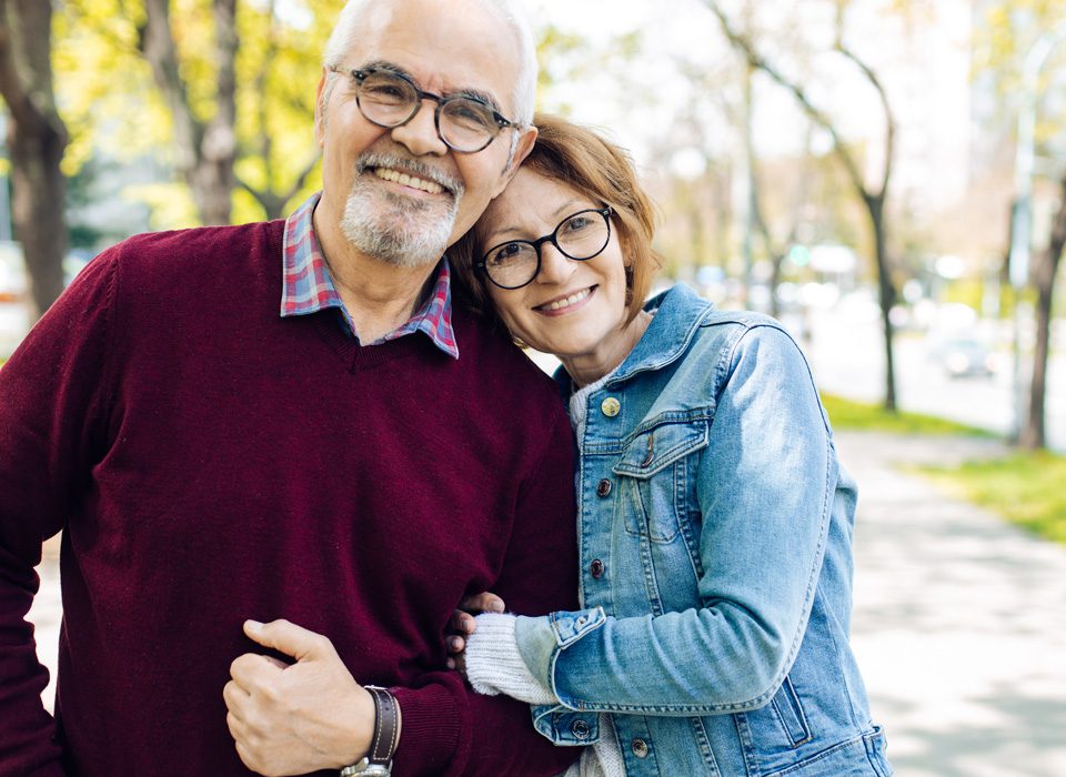 Older-couple-smiling-outdoors